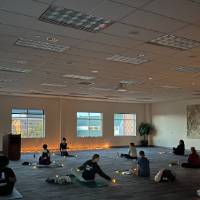 Students sit to begin candlelight yoga